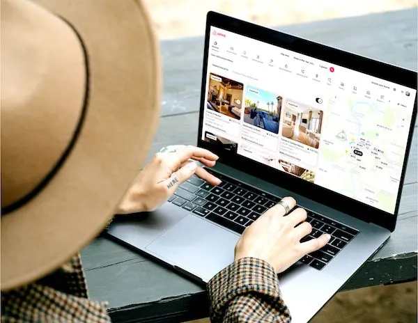 person researching airbnb on a laptop