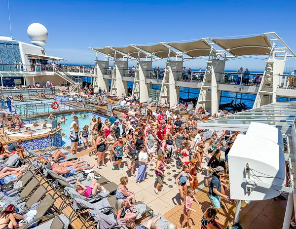 lots of people dancing on the celebrity solstice pool deck