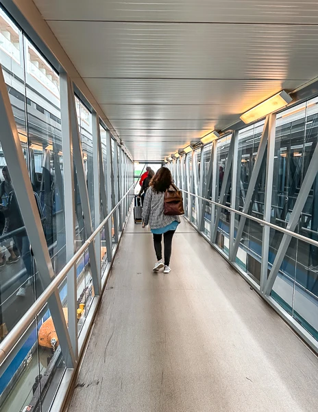 woman walking up the gangway embarking a cruise ship