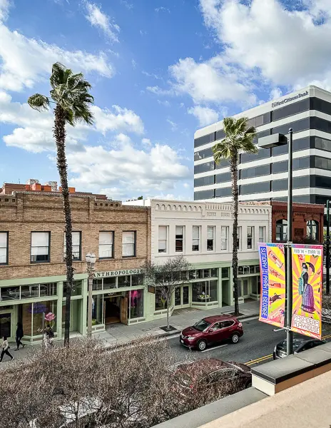 Streetscape of Fair Oaks Avenue in Old Pasadena, with shops and palm trees, highlighting the unique architecture and vibrant atmosphere of the area.