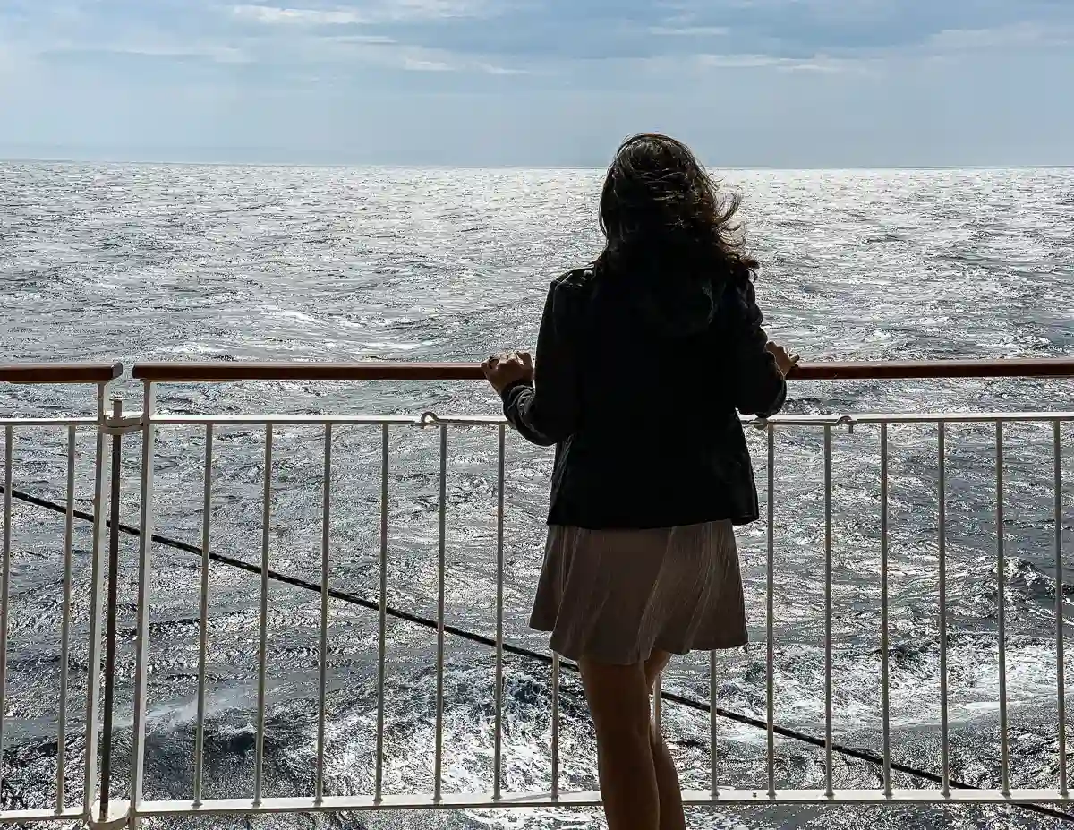 kathy on a cruise ship staring out into the ocean