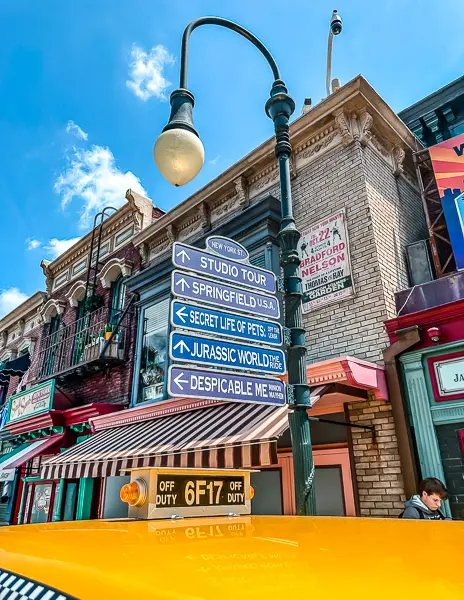 signs pointing to the rides at universtal studios hollywood