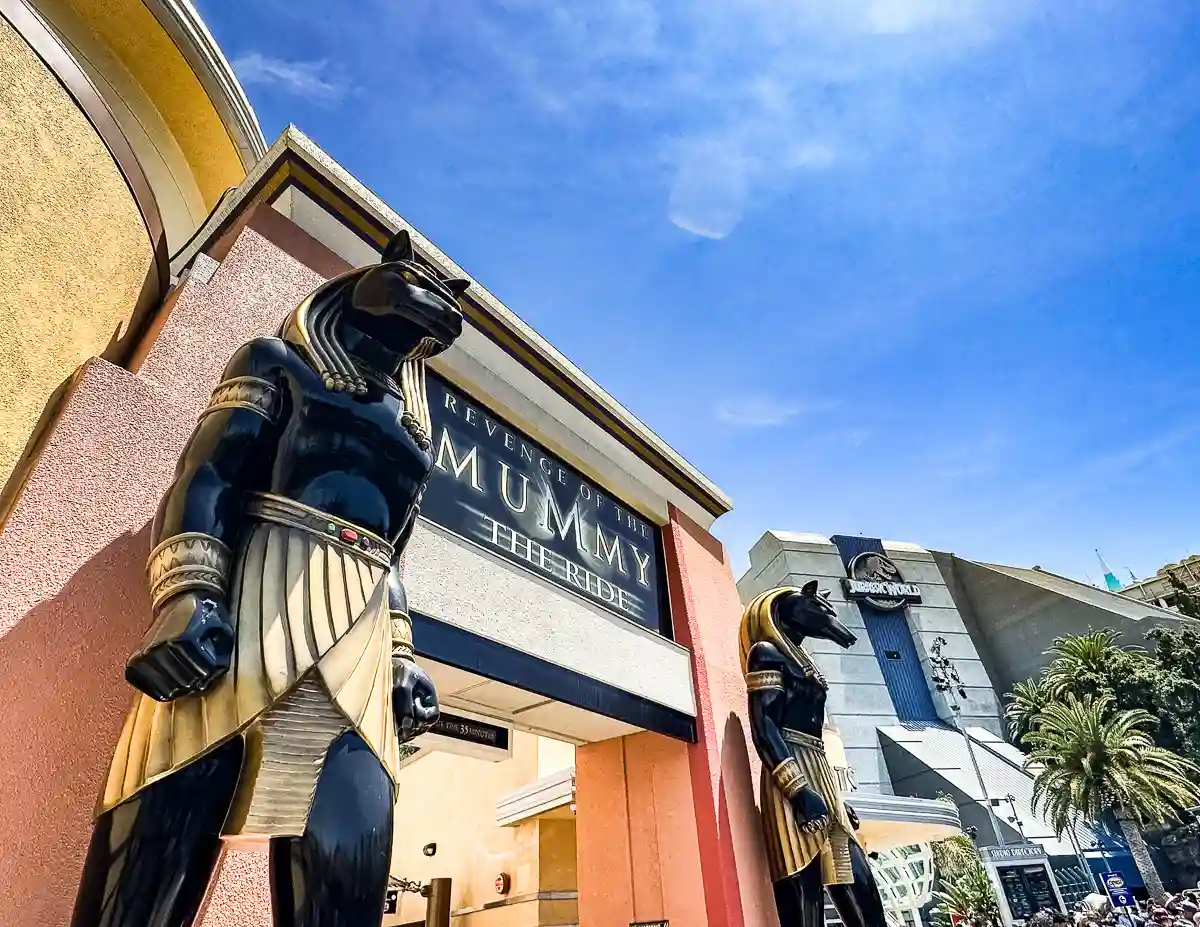 standing outside the mummy ride staring at two Egyptian statues guarding the entrance at universal studios hollywood