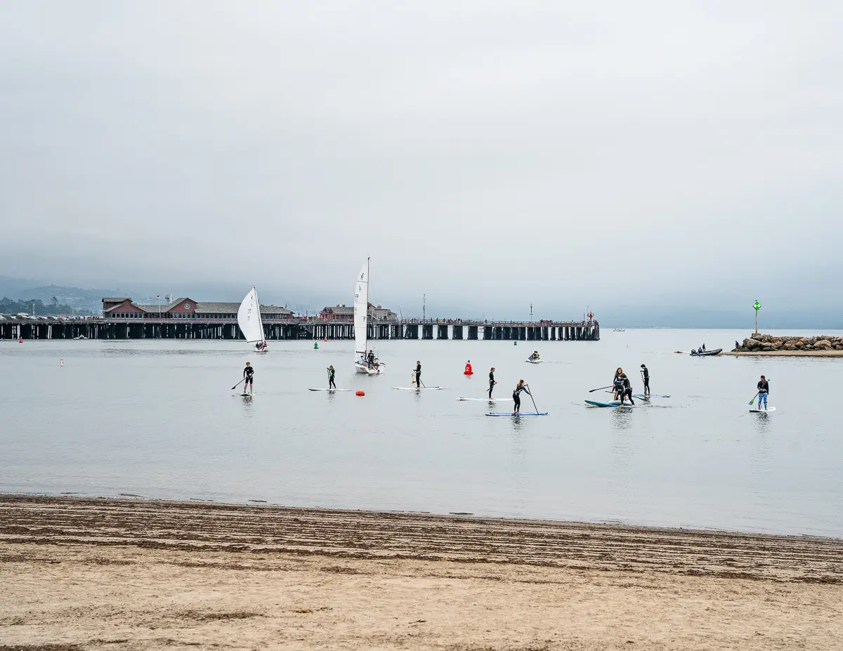 paddle boards out on west beach waters in santa barbara on an early chilly morning