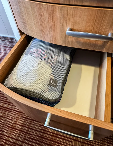 stuffed packing cube inside a drawer inside cruise cabin