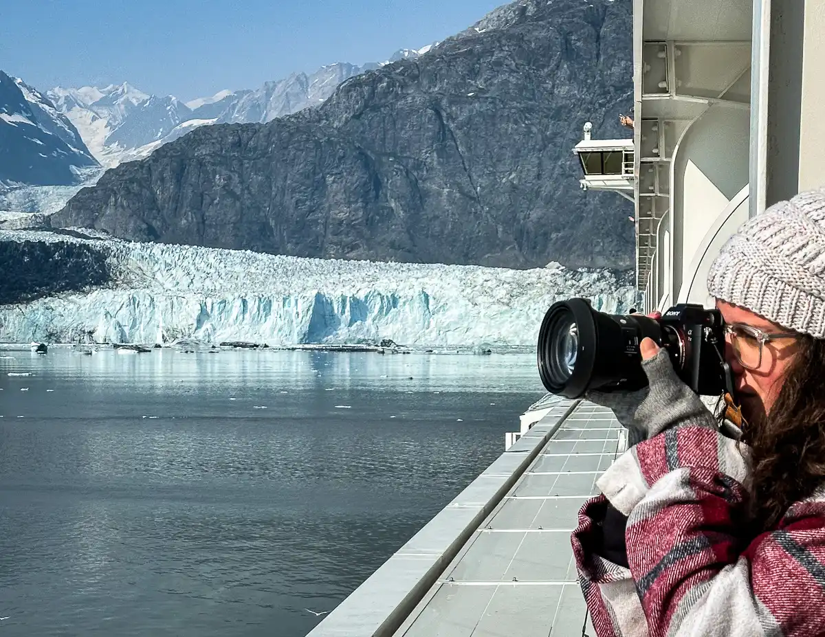 kathy taking photos with her mirrorless sony with a glacier in the background