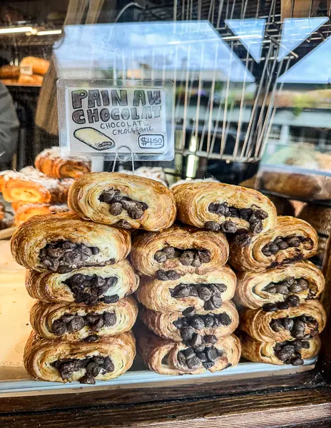 chocolate croissants piled against the window at three girls bakery in seattle