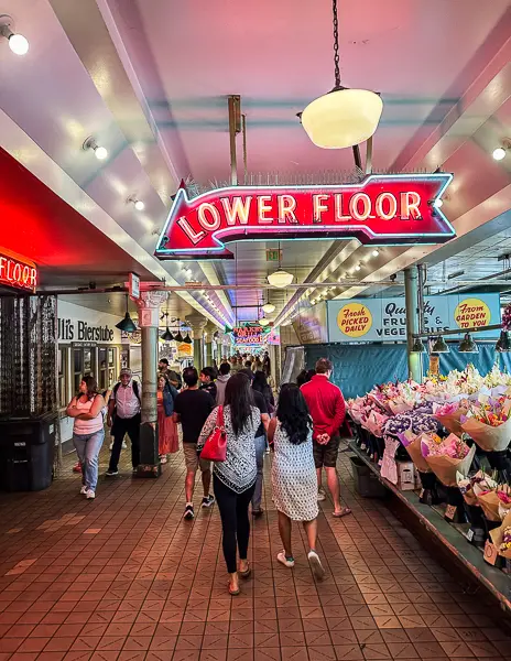 neon sign with letters that read lower floor at pike place in seattle