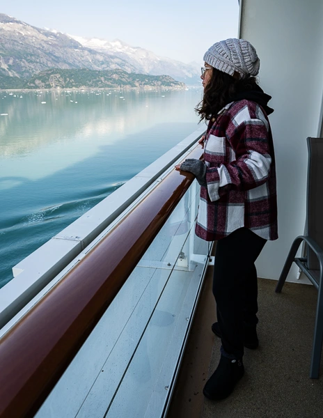 women wearing warm layers while on cruise balcony for an alaskan cruise