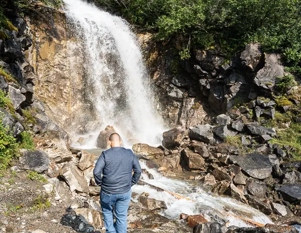 man walking towards bridal veil falls