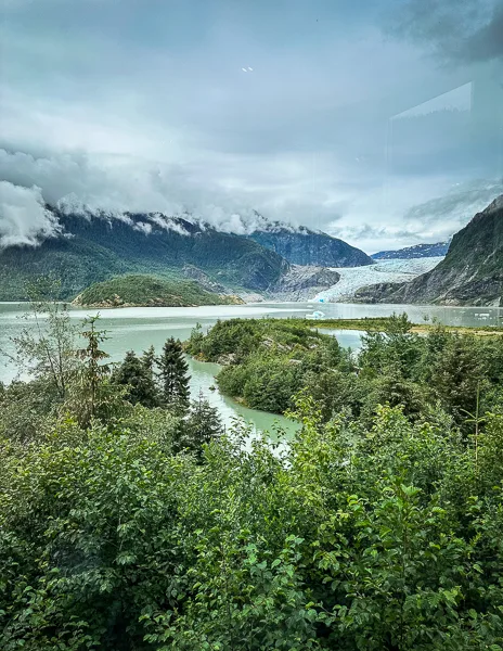 View from the Photo Point Trail at Mendenhall Glacier, offering a panoramic perspective of the glacier, lake, and surrounding mountains.