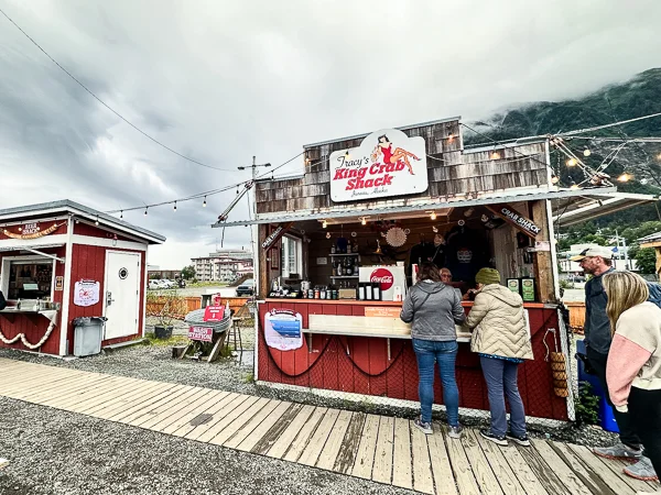 Tracy's King Crab Shack outdoor bar in Juneau, showcasing a rustic setup with string lights and a welcoming atmosphere.