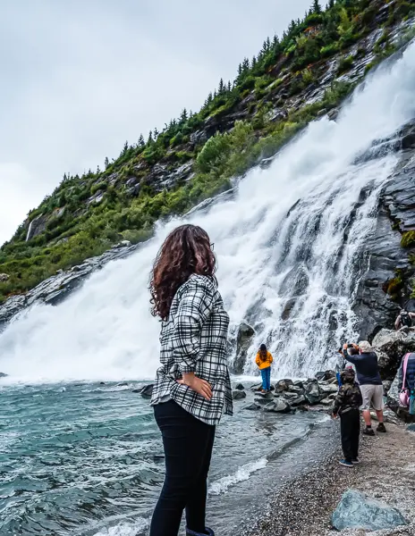 kathy standing near nugget falls at mendenhall glacier national park