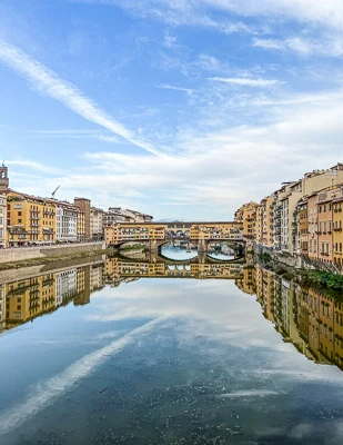 ponte vecchio and arno river on a beautiful day in florence italy