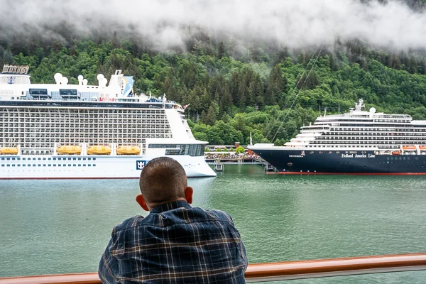 man admiring cruise ships docked in juneau alaska