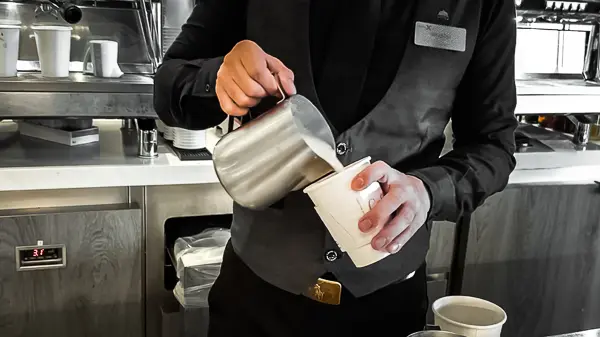 barista preparing coffee at cafe al bacio on celebrity beyond