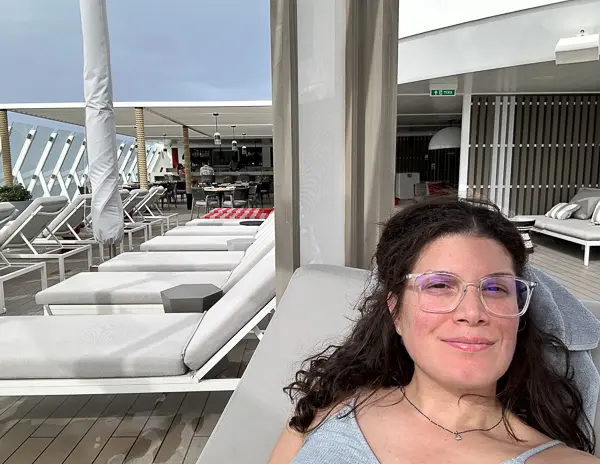 kathy laying back and enjoying the retreat pool deck celebrity beyond