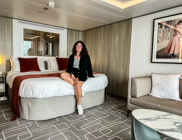 kathy sitting on the bed in the celebrity beyond sky suite