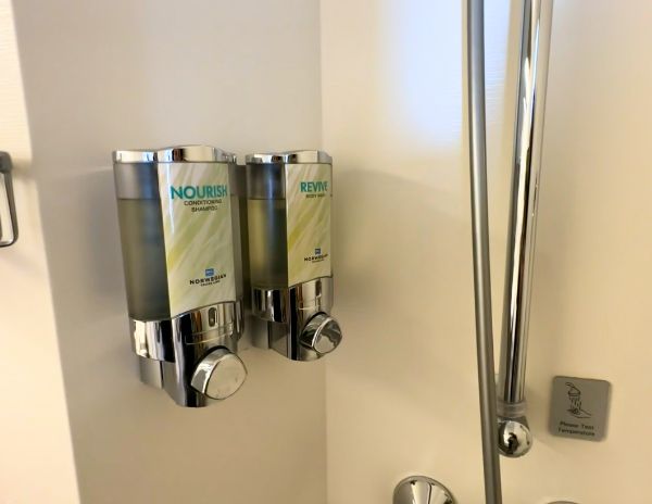 shampoo and body soap dispenser in the shower of ncl cabin