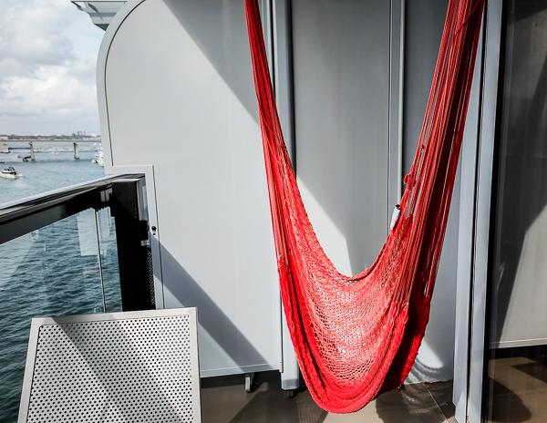 red hammock on a sea terrace balcony on virgin voyages