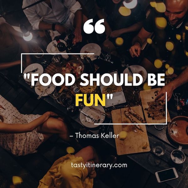 The image shows a lively dining scene with an overhead view of a table and people eating, paired with the quote “FOOD SHOULD BE FUN” by Thomas Keller, set against a dark background with yellow bokeh lights.