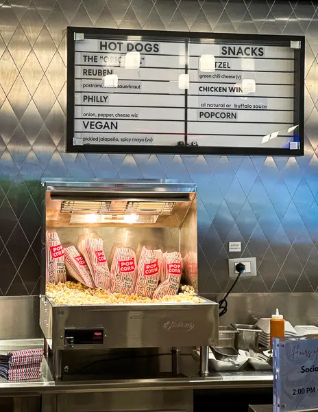 a popcorn machine filled with bags of popcorn ready to grab and go.