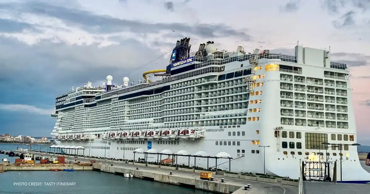Norwegian Epic docked at port under a cloudy sky before heading into dry dock for scheduled upgrades.