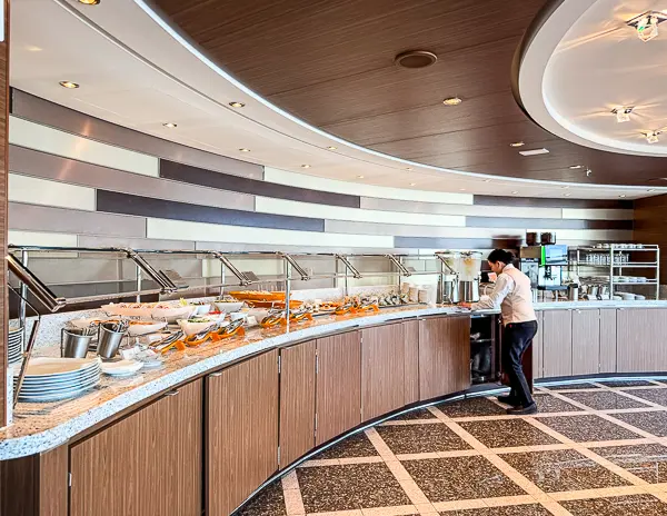 Buffet-style snack station in The Haven Observation Lounge on Norwegian Encore, offering light bites, treats, and coffee throughout the day