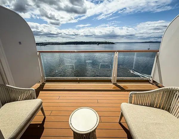 The larger balcony from Haven Penthouse Suite 17112 on Norwegian Encore—plenty of space to sit back and watch the scenery.