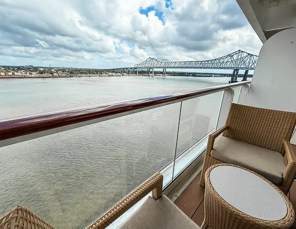 View from The Haven Suite 14138 balcony on Norwegian Getaway, featuring the Mississippi River and Crescent City Connection bridge in the distance.