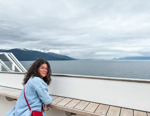 Kathy enjoying the views from The Haven sundeck on Norwegian Encore during an Alaska cruise