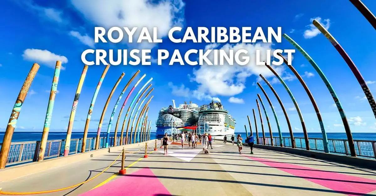 featured blog image: Cruise passengers walk along the colorful, art-lined dock at CocoCay toward two docked Royal Caribbean ships, with the text “ROYAL CARIBBEAN CRUISE PACKING LIST” overlaid in bold white letters across the sky.