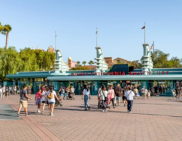 Entrance to Disney California Adventure with guests walking in on a sunny morning
