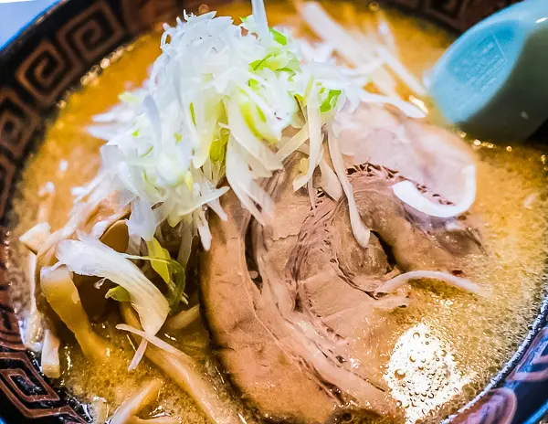 Bowl of Sapporo-style miso ramen topped with pork, cabbage, and bean sprouts/