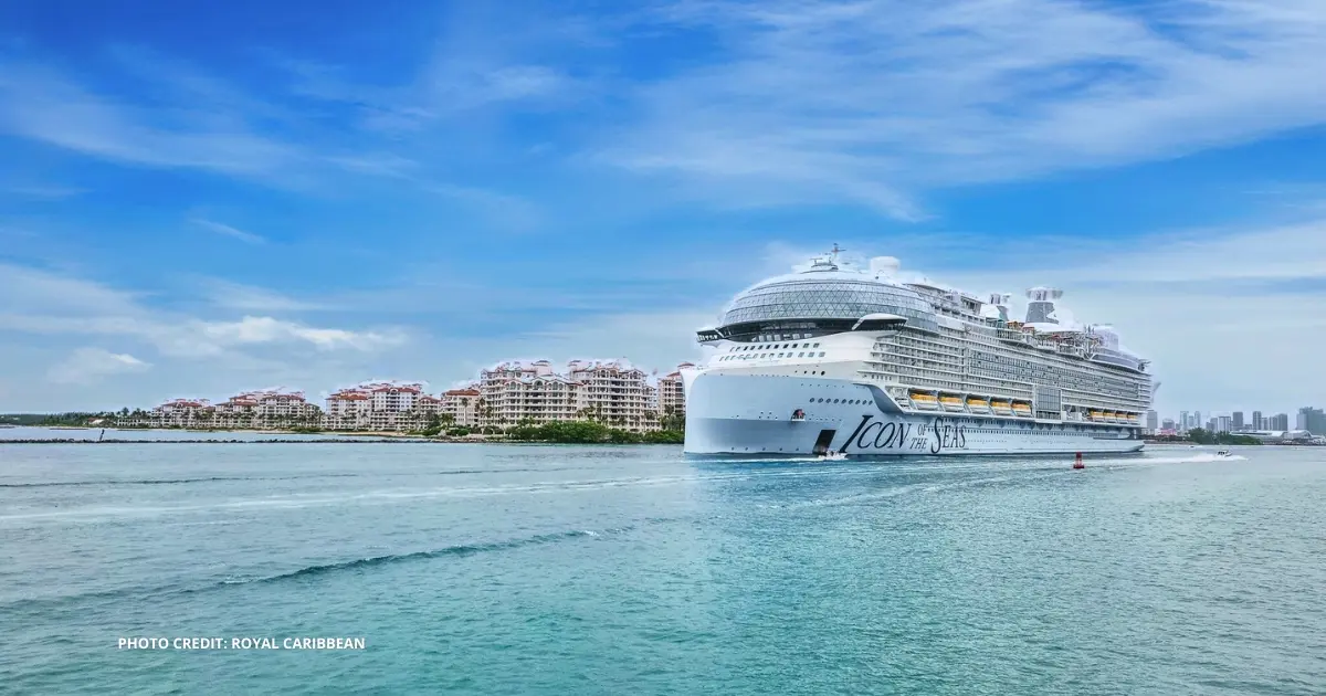 featured image: Aerial view of Royal Caribbean’s Icon-class cruise ship at sea, showing colorful pools, water slides, and deck areas lit up at night.
