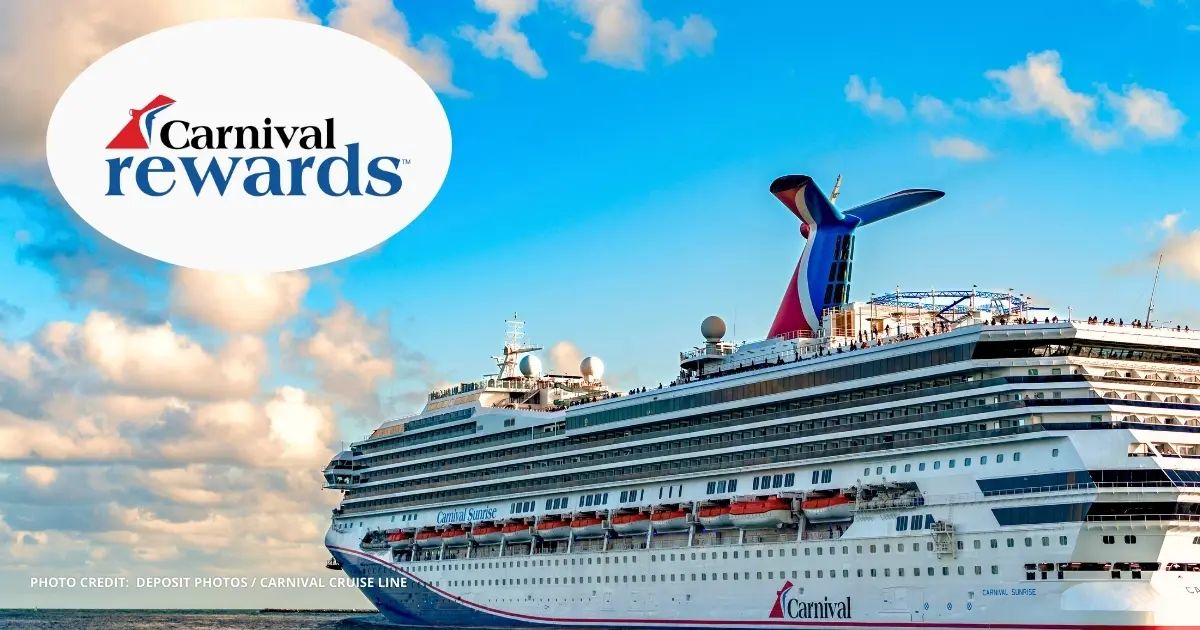 A Carnival Cruise Line ship sailing under a bright blue sky with the Carnival funnel visible. The Carnival Rewards logo appears in the upper left corner of the image.