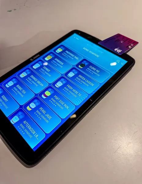 Ordering tablet at the Bionic Bar on Quantum of the Seas, showing the cocktail menu screen with a SeaPass card.