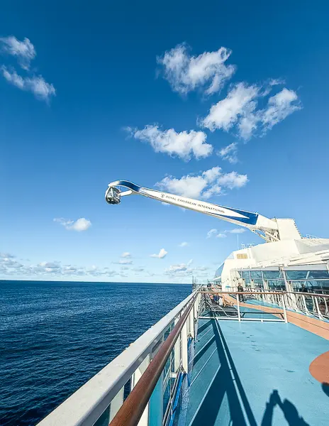 North Star observation arm extended over the ocean on Quantum of the Seas, set against a bright blue sky.
