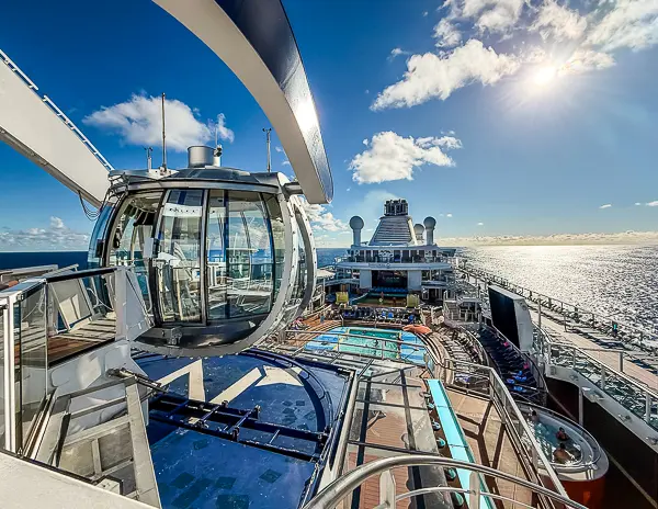 North Star capsule on Royal Caribbean’s Quantum of the Seas overlooking the outdoor pool deck on a sunny sea day.