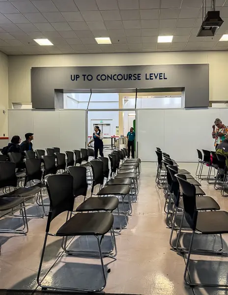 Waiting area inside the Port of Los Angeles cruise terminal, with chairs set up for passengers holding The Key before boarding Quantum of the Seas.