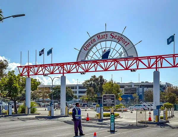 Entrance to the Queen Mary Seaport in Long Beach, showing the main sign and parking area near the Carnival cruise terminal.