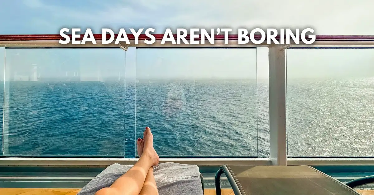 featured blog image: Cruiser relaxing on a lounge chair with legs stretched out toward a cruise ship railing and open ocean, with overlay text reading “SEA DAYS AREN’T BORING.”