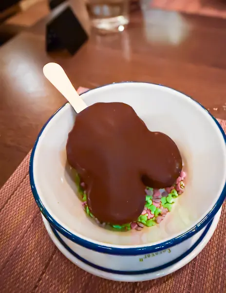 Mickey ice cream bar served as dessert in the main dining room on a Disney cruise.