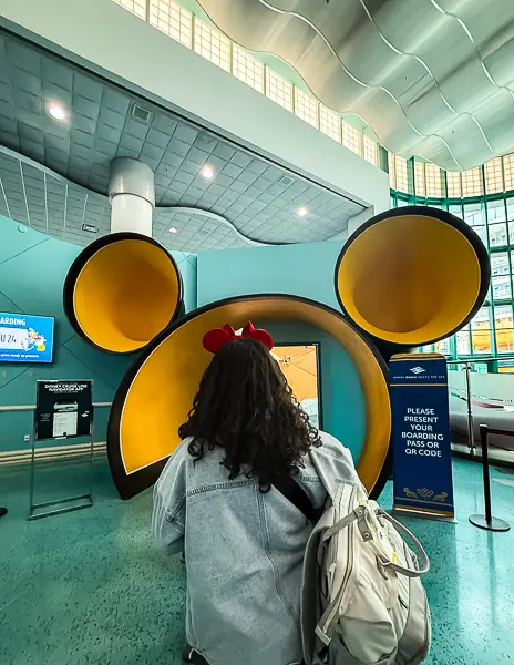 Guest (Kathy) wearing Mickey ears boarding a Disney cruise ship at Port Canaveral after completing online check-in.