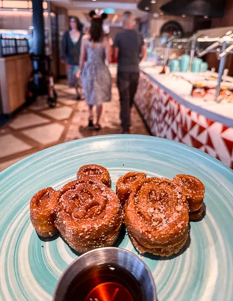 Mickey churro waffles served at the Disney cruise breakfast buffet with maple syrup.