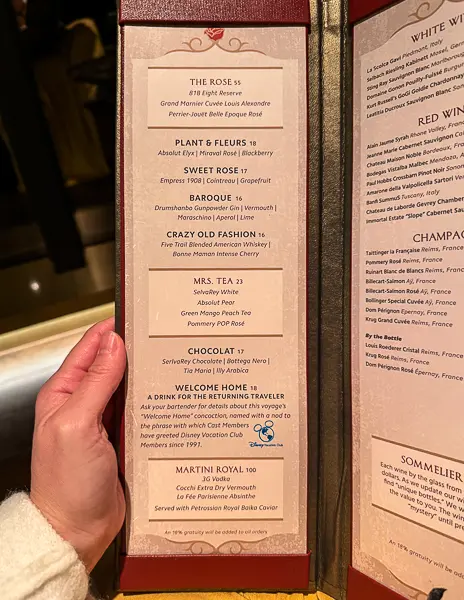 lose-up of The Rose cocktail menu on Disney Treasure showing specialty drinks and wine selections.