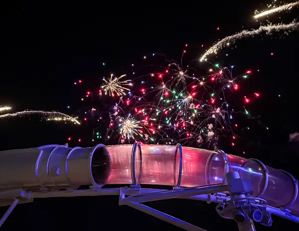 Disney Cruise Line fireworks during Pirate Night lighting up the sky above the AquaDuck waterslide on the ship’s upper deck.