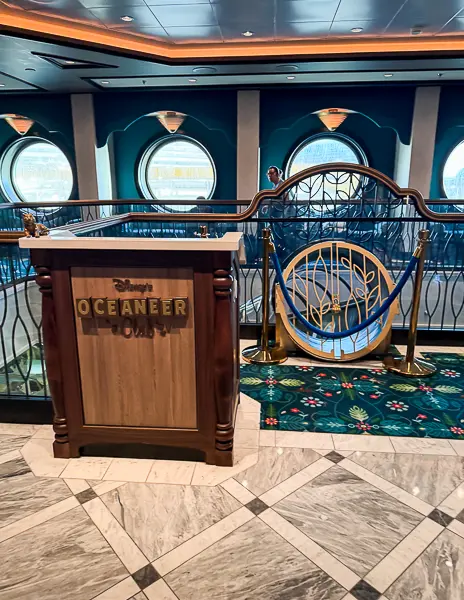 Entrance to the Oceaneer Club kids area on a Disney Cruise Line ship, featuring the slide entrance and themed decor inside the kids club.