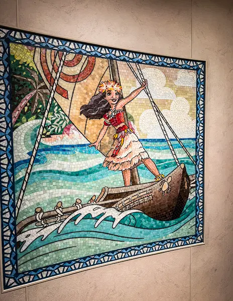Moana mosaic artwork displayed on a wall aboard the Disney Treasure cruise ship, reflecting the Disney storytelling and themed details found throughout the ship.