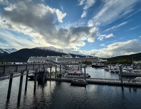 Skagway cruise port with cruise ships docked against snowcapped mountains after returning from the Glacier Point Wilderness Safari tour.